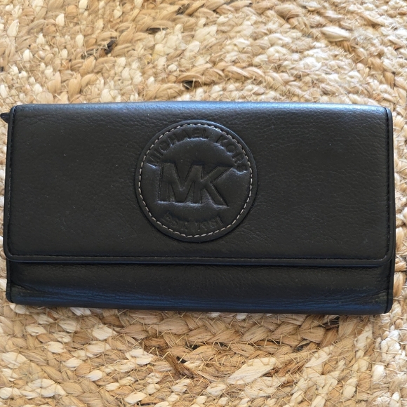 Michael Kors Handbags - Michael Kors Black Leather Flap Wallet with Embossed MK Emblem